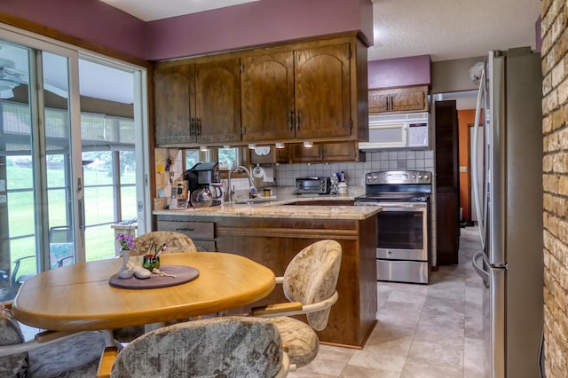 5225 217th St N, Forest Lake, MN 55025 - kitchen featuring stainless steel appliances, a sink, a peninsula, and healthy amount of natural light
