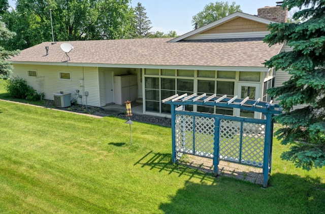 5225 217th St N, Forest Lake, MN 55025 - back of property featuring roof with shingles, central air condition unit, a yard, a chimney, and a sunroom