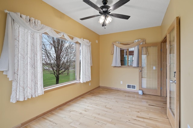 26722 Rabbit Trl, Stanford Twp, MN 55398 - unfurnished room featuring wood finished floors, healthy amount of natural light, and a ceiling fan