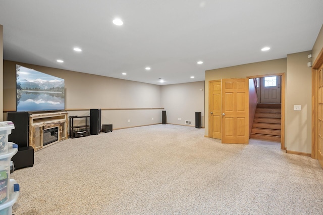 26722 Rabbit Trl, Stanford Twp, MN 55398 - unfurnished living room with recessed lighting, carpet, stairs, and a glass covered fireplace