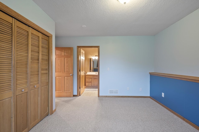 26722 Rabbit Trl, Stanford Twp, MN 55398 - unfurnished bedroom with light carpet, a closet, a textured ceiling, and ensuite bathroom
