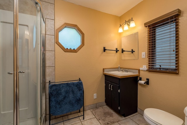 242 Skyview Ln, Mankato, MN 56001 - full bathroom with vanity, a shower stall, tile patterned floors, and toilet