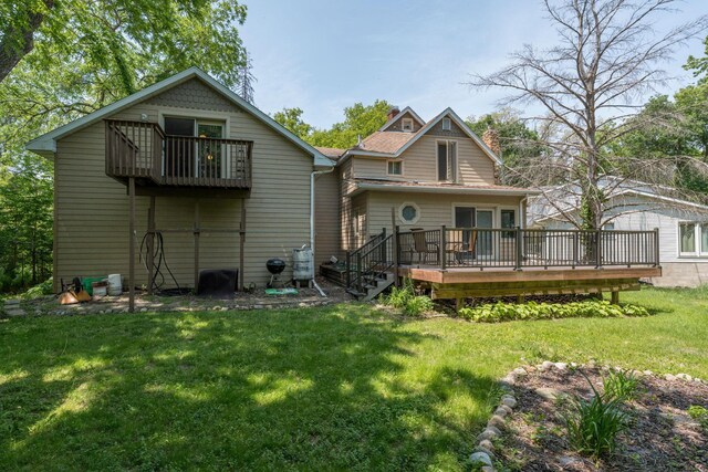 242 Skyview Ln, Mankato, MN 56001 - back of house with a wooden deck, a lawn, and a chimney
