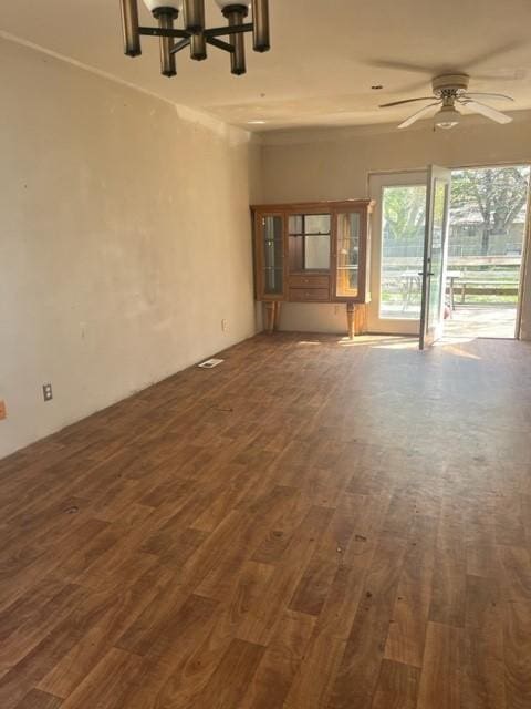 718 9th St N, Mountain Lake, MN 56159 - unfurnished living room featuring a chandelier, dark wood-style flooring, and a ceiling fan