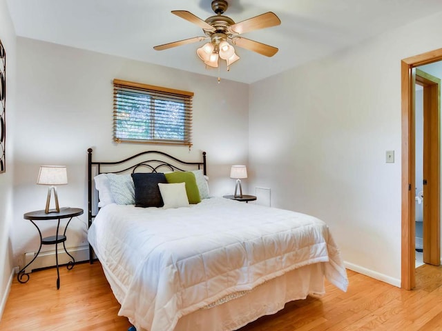 656 Ashland Ave Unit 11, Saint Paul, MN 55104 - bedroom with a baseboard radiator, light wood-type flooring, and ceiling fan