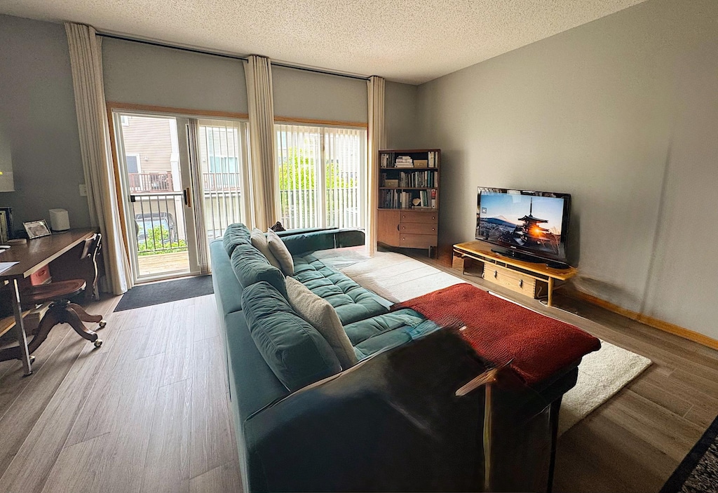 4332 Victor Path Unit 6, Hugo, MN 55038 - living area with wood finished floors, a textured ceiling, and an office area