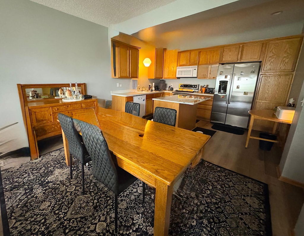 4332 Victor Path Unit 6, Hugo, MN 55038 - dining area featuring wood finished floors and a textured ceiling