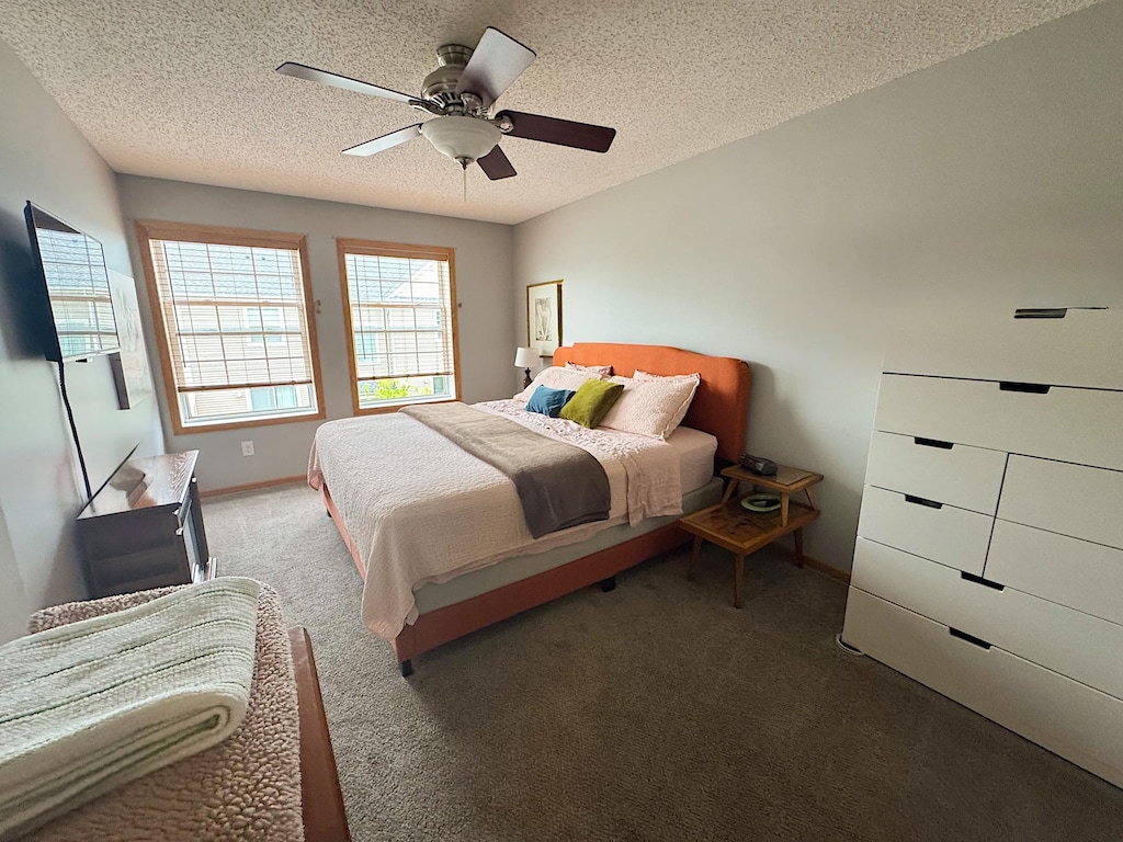 4332 Victor Path Unit 6, Hugo, MN 55038 - carpeted bedroom featuring a textured ceiling, a ceiling fan, and baseboards
