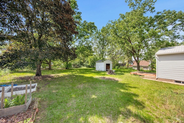 2400 108th Ave NW, Coon Rapids, MN 55433 - view of grassy yard featuring a vegetable garden