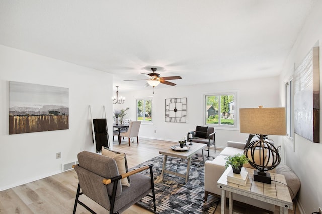 1173 Jefferson St S, Shakopee, MN 55379 - living room featuring light wood-style floors, ceiling fan, a chandelier, and baseboards