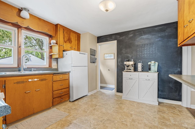1514 2nd St N, Fargo, ND 58102 - kitchen featuring freestanding refrigerator, a sink, and brown cabinets