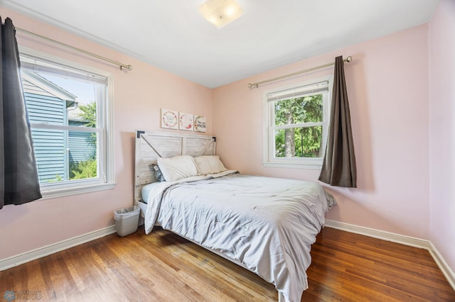 1514 2nd St N, Fargo, ND 58102 - bedroom with baseboards, multiple windows, and wood finished floors