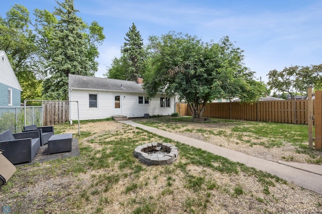 1514 2nd St N, Fargo, ND 58102 - back of house featuring a fire pit, a fenced backyard, entry steps, and a chimney