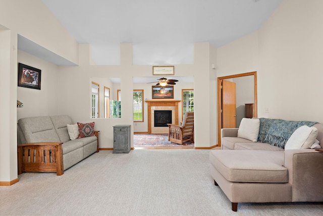 4645 Eagle Ridge Ln, Monticello, MN 55362 - carpeted living area featuring a tiled fireplace, ceiling fan, and baseboards