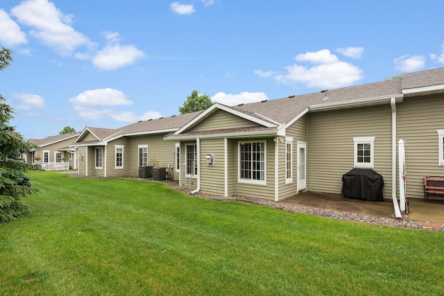 4645 Eagle Ridge Ln, Monticello, MN 55362 - rear view of property with a patio, a yard, a shingled roof, and central air condition unit
