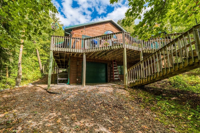 4050 Gryce Styne Rd NE, Bemidji, MN 56601 - rear view of property with an attached garage, a wooden deck, and stairway