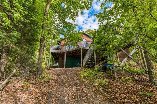 4050 Gryce Styne Rd NE, Bemidji, MN 56601 - back of property featuring stairs, a deck, and a garage