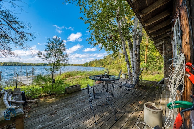 4050 Gryce Styne Rd NE, Bemidji, MN 56601 - wooden deck with a water view and outdoor dining space