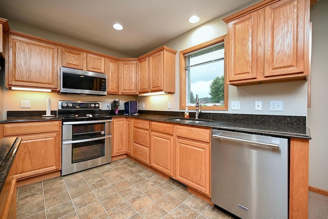 705 14th St, Wabasha, MN 55981 - kitchen with stainless steel appliances, a sink, recessed lighting, and dark stone countertops