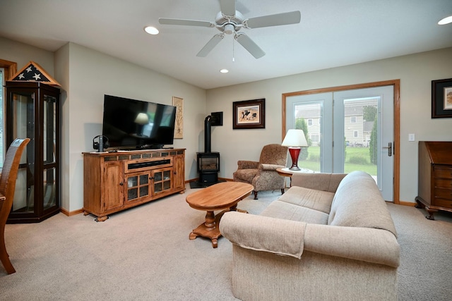 705 14th St, Wabasha, MN 55981 - living area with light colored carpet, ceiling fan, baseboards, recessed lighting, and a wood stove
