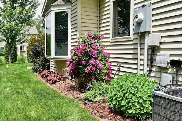 705 14th St, Wabasha, MN 55981 - view of home's exterior featuring central AC unit and a lawn