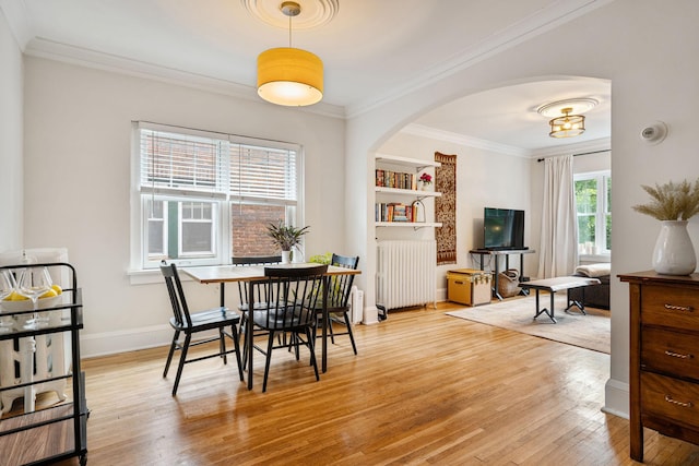 3409 Emerson Ave S Unit 4, Minneapolis, MN 55408 - dining room featuring radiator, arched walkways, wood finished floors, ornamental molding, and baseboards