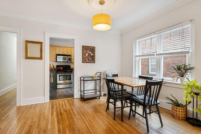 3409 Emerson Ave S Unit 4, Minneapolis, MN 55408 - dining space featuring ornamental molding, light wood-style floors, and baseboards
