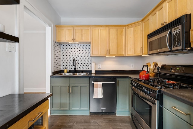 3409 Emerson Ave S Unit 4, Minneapolis, MN 55408 - kitchen featuring appliances with stainless steel finishes, dark countertops, a sink, and dark wood-style flooring
