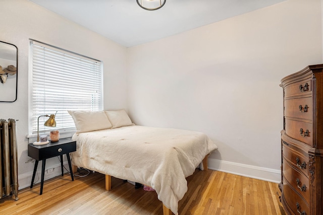 3409 Emerson Ave S Unit 4, Minneapolis, MN 55408 - bedroom with light wood finished floors, radiator, and baseboards