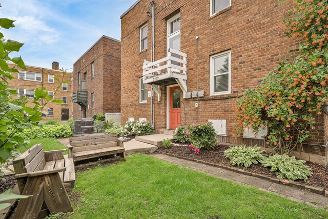 3409 Emerson Ave S Unit 4, Minneapolis, MN 55408 - entrance to property with a balcony, brick siding, and a lawn
