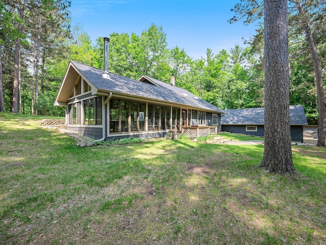 3709 Half Moon Cir, Jackson Twp, WI 54830 - back of house with a sunroom, a yard, and a chimney