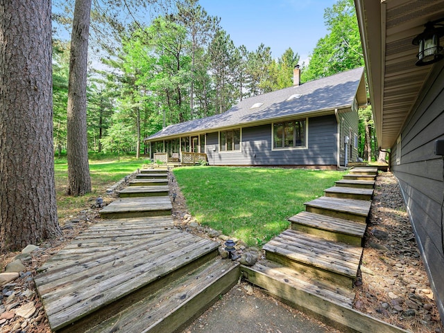 3709 Half Moon Cir, Jackson Twp, WI 54830 - back of property featuring a yard, a shingled roof, stairs, and a chimney