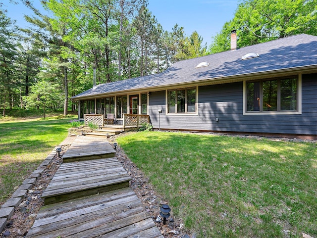 3709 Half Moon Cir, Jackson Twp, WI 54830 - view of front of house with a front lawn, a chimney, and roof with shingles
