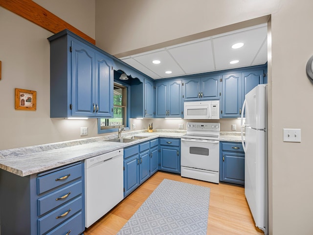 3709 Half Moon Cir, Jackson Twp, WI 54830 - kitchen with white appliances, recessed lighting, blue cabinets, light countertops, and light wood finished floors