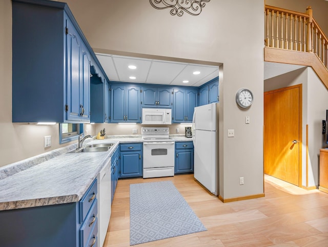 3709 Half Moon Cir, Jackson Twp, WI 54830 - kitchen with white appliances, blue cabinets, light wood finished floors, recessed lighting, and light countertops