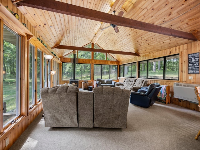 3709 Half Moon Cir, Jackson Twp, WI 54830 - carpeted living room with heating unit, a wood stove, wood walls, a ceiling fan, and wooden ceiling
