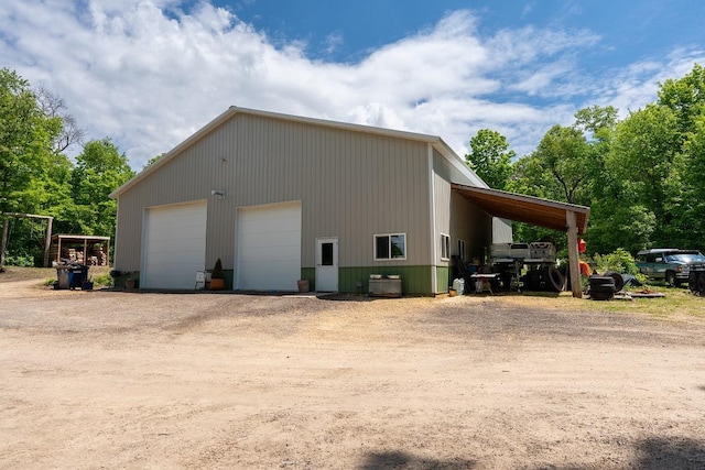 N1024 385th St, Maiden Rock, WI 54750 - view of property exterior with a detached garage, an outbuilding, and driveway