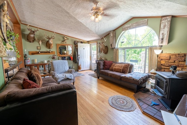 N1024 385th St, Maiden Rock, WI 54750 - living room with a textured ceiling, vaulted ceiling, a wood stove, hardwood / wood-style flooring, and ceiling fan
