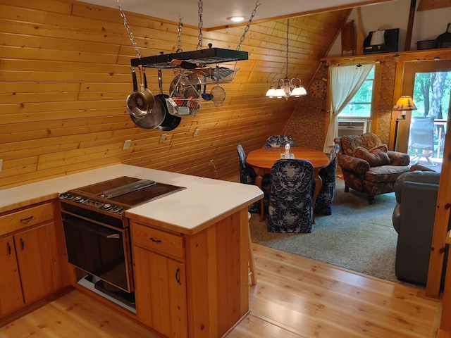 76683 Long Lake Rd, Kettle River Twp, MN 55795 - kitchen featuring range with electric cooktop, wood walls, light wood-type flooring, light countertops, and vaulted ceiling
