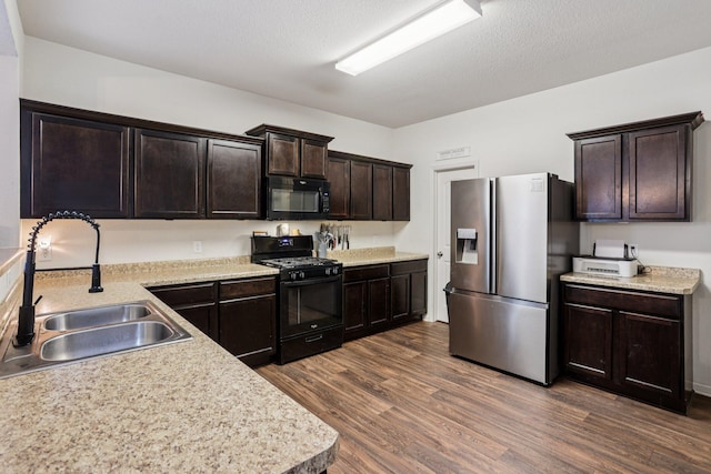 1104 Foede Cir, Montrose, MN 55363 - kitchen with black appliances, a sink, light countertops, and dark brown cabinetry