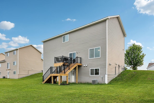 1104 Foede Cir, Montrose, MN 55363 - back of property with stairs, a wooden deck, a lawn, and central air condition unit