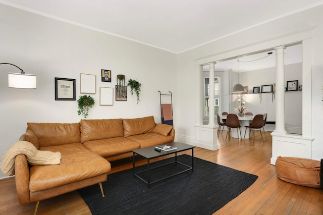 681 Dayton Ave, Saint Paul, MN 55104 - living room featuring ornate columns, hardwood / wood-style flooring, crown molding, and baseboards