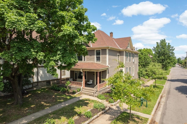 681 Dayton Ave, Saint Paul, MN 55104 - view of front of home with a porch, a chimney, and roof with shingles