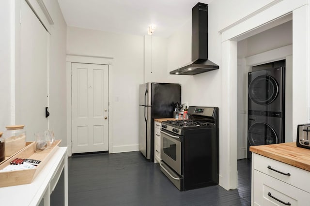 681 Dayton Ave, Saint Paul, MN 55104 - kitchen featuring appliances with stainless steel finishes, wall chimney exhaust hood, stacked washer / drying machine, butcher block countertops, and dark wood-style floors