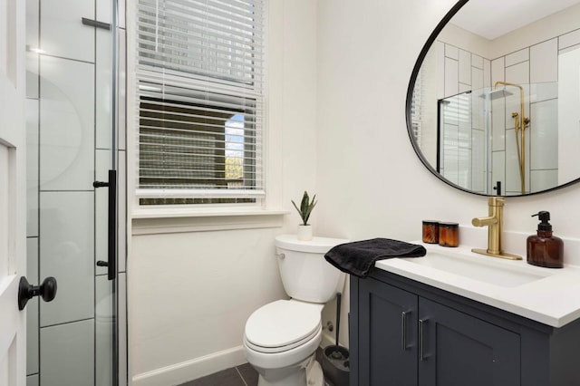 681 Dayton Ave, Saint Paul, MN 55104 - bathroom featuring vanity, toilet, a shower stall, tile patterned floors, and baseboards