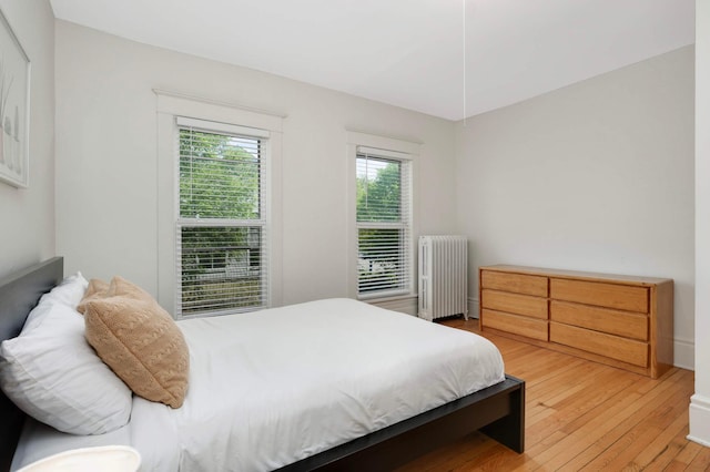 681 Dayton Ave, Saint Paul, MN 55104 - bedroom featuring radiator heating unit and light wood-type flooring