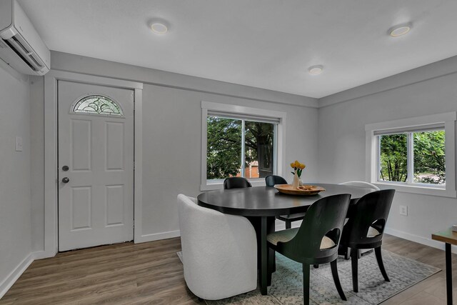 17 Riverside Ave S, Sartell, MN 56377 - dining room with a wall mounted air conditioner, plenty of natural light, baseboards, and wood finished floors