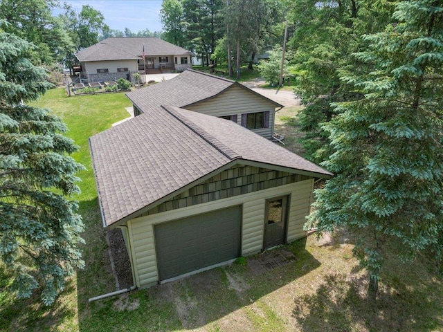 9174 Aloha Ln, Pelican Twp, MN 56472 - view of front of home featuring a shingled roof, a garage, and a front lawn