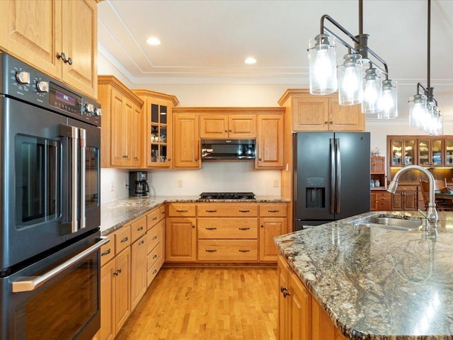 9174 Aloha Ln, Pelican Twp, MN 56472 - kitchen featuring refrigerator with ice dispenser, a sink, double oven, light wood-type flooring, and stone countertops