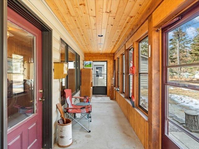 9174 Aloha Ln, Pelican Twp, MN 56472 - sunroom / solarium featuring concrete floors, plenty of natural light, wooden ceiling, and wooden walls